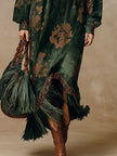 Green faux suede tassel maxi dress for women by FJØRNA, flowing fabric with tassel details, styled for elegant wear.