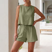 Green women's summer two-piece pleated co-ord set by FJØRNA, featuring matching top and skirt in a stylish, lightweight design.