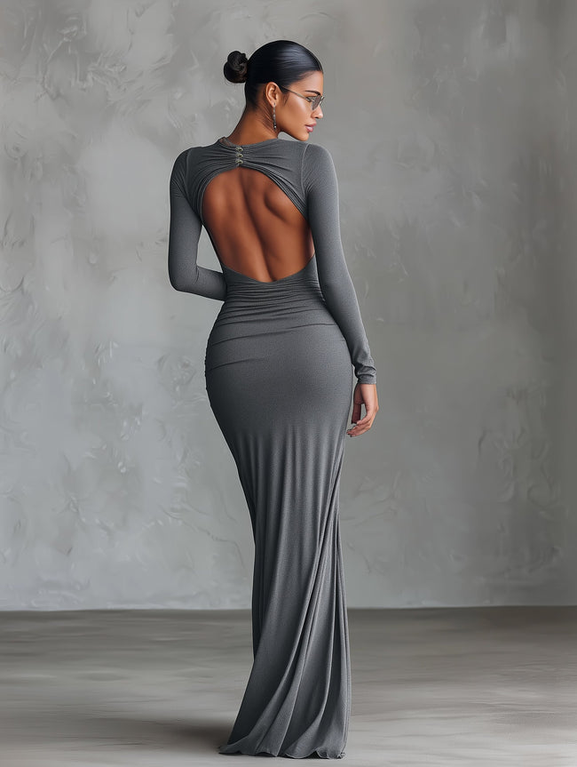 Grey knit ruched maxi dress by FJØRNA, featuring a fitted silhouette and elegant evening style, shown on a model.