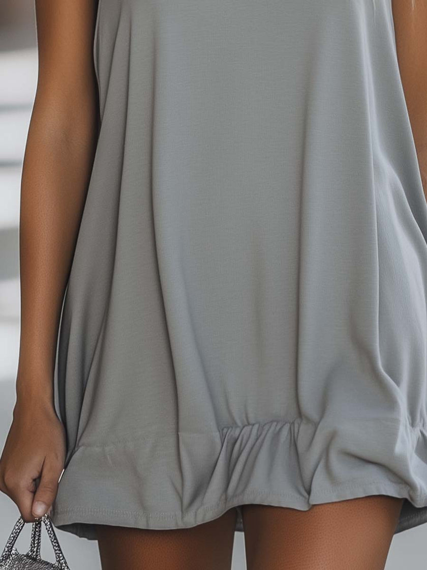 Grey FJØRNA sleeveless mini dress, casual style, shown on a model with a relaxed fit and simple design, perfect for everyday wear.