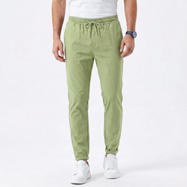 FJØRNA men's stretchable comfort trousers with a slim fit design, shown in a neutral color, featuring a classic waistband and front pockets.