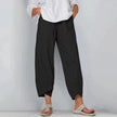 FJØRNA women's lightweight summer tapered trousers in breathable fabric, beige color, fitted waist, and relaxed fit for warm weather.