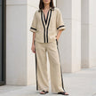 Khaki FJØRNA women's two-piece co-ord set with wide-leg pants and V-neck top, stylish and elegant for casual or dressy wear.