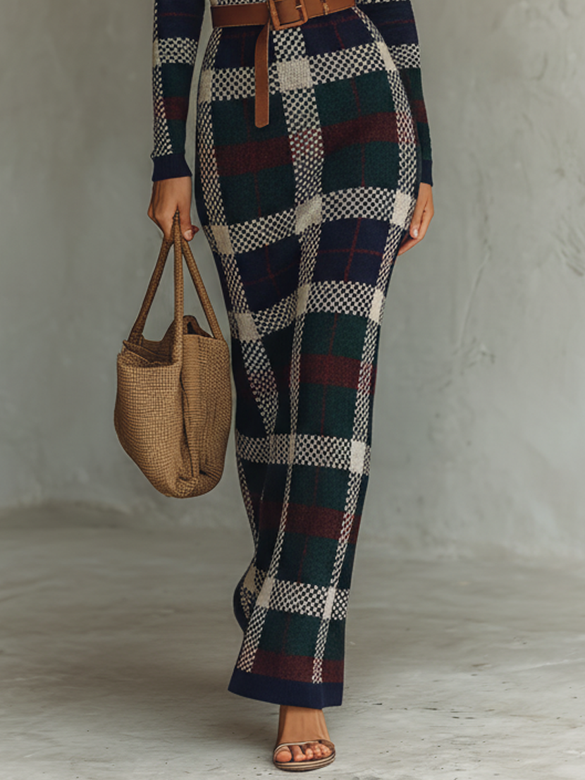 FJØRNA women's knit maxi dress displayed on a model, featuring a flowing silhouette and long sleeves in soft knit fabric.