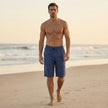 Men's beige linen chino shorts with drawstring waist, styled casually, by FJØRNA, perfect for warm weather and relaxed looks.