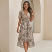 FJØRNA elegant midi dress for women with v-neck, short sleeves, and wrap design, shown in a stylish lifestyle setting.