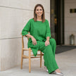 FJØRNA women's summer two-piece asymmetric co-ord set worn in a stylish lifestyle setting, featuring a matching top and skirt.