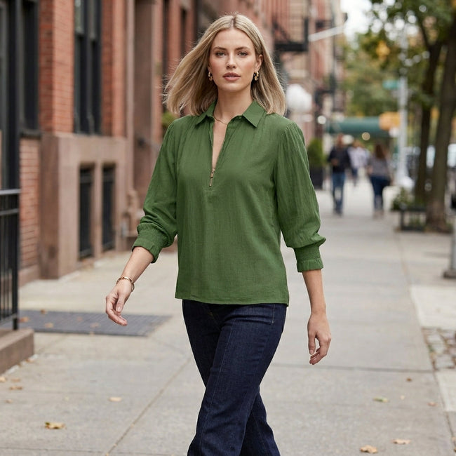 Women’s summer blouse by FJØRNA with long sleeves and smocked design, worn casually outdoors in a lifestyle setting.