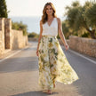 FJØRNA elegant two-piece women's floral co-ord set with wide-leg pants and halter neck top, styled in a casual outdoor setting.