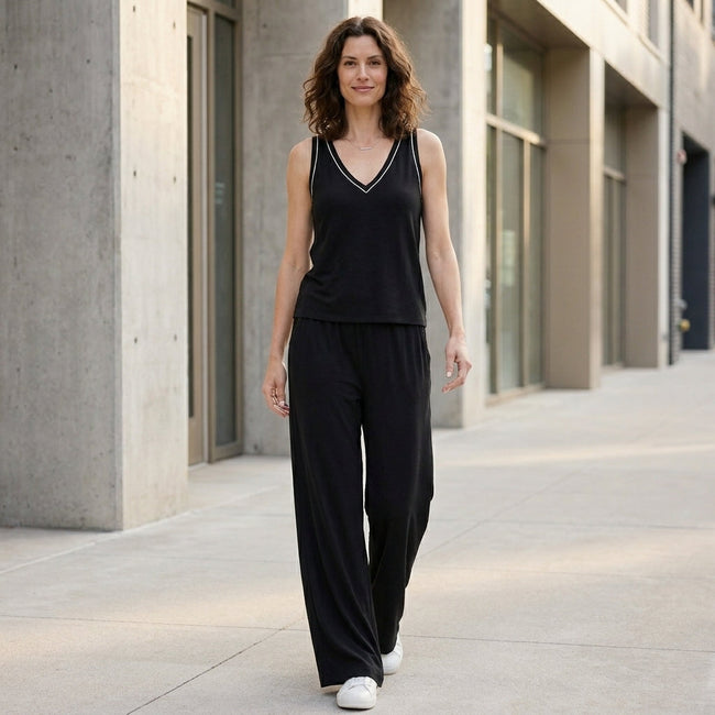 FJØRNA women's summer two-piece set featuring a wide-leg design and V-neck top, styled in a casual, outdoor setting.