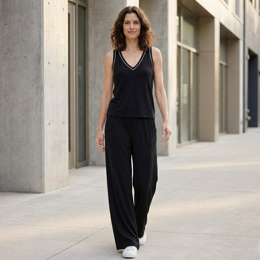 FJØRNA women's summer two-piece set featuring a wide-leg design and V-neck top, styled in a casual, outdoor setting.