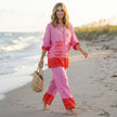 FJØRNA women's summer two-piece co-ord set with geometric pockets and V-neck, styled in a casual outdoor setting.