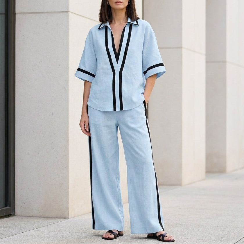Light blue FJØRNA women's two-piece co-ord set with wide-leg pants and V-neck top, showcasing elegant casual style.