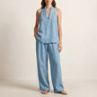 Light blue women's summer two-piece co-ord set from FJØRNA with V-neck top and matching shorts, featuring pockets and lightweight fabric.