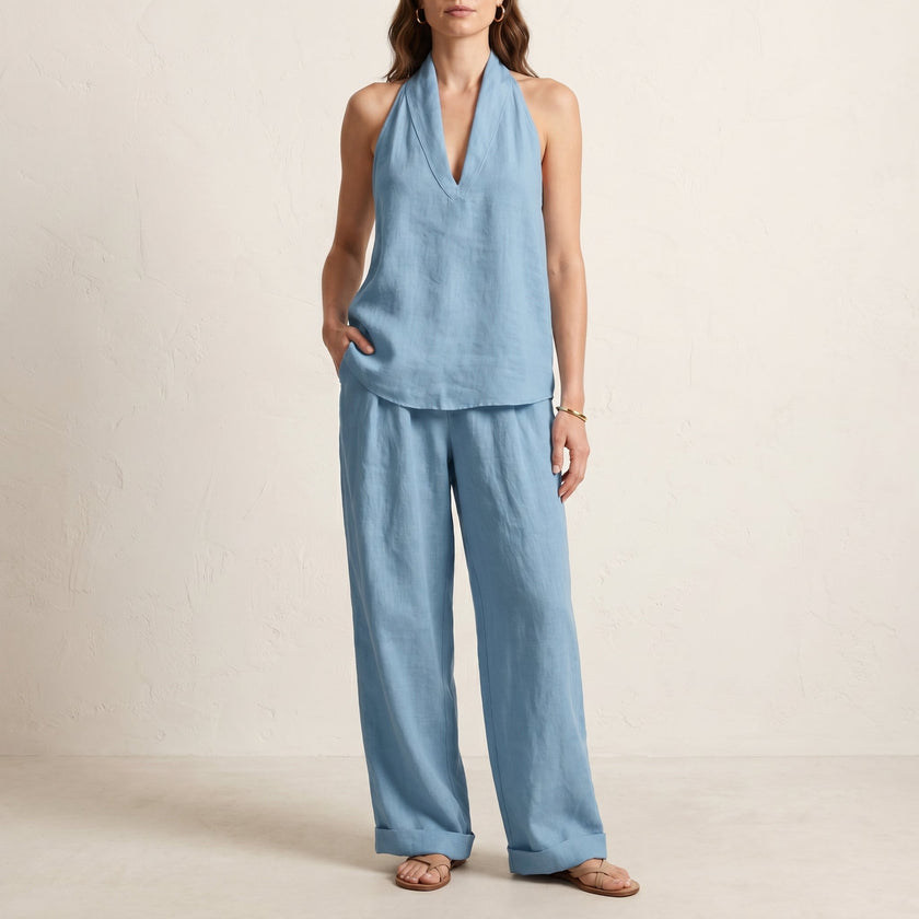 Light blue women's summer two-piece co-ord set from FJØRNA with V-neck top and matching shorts, featuring pockets and lightweight fabric.