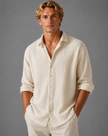 Men's textured linen-look button-up shirt in relaxed summer fit by FJØRNA, shown on a male model.