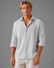 Men's textured linen-look button-up shirt in relaxed summer fit by FJØRNA, shown in a casual men's shirt style image.