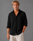 Men's linen-look textured button-up shirt in relaxed summer fit, by FJØRNA, shown on a male model.