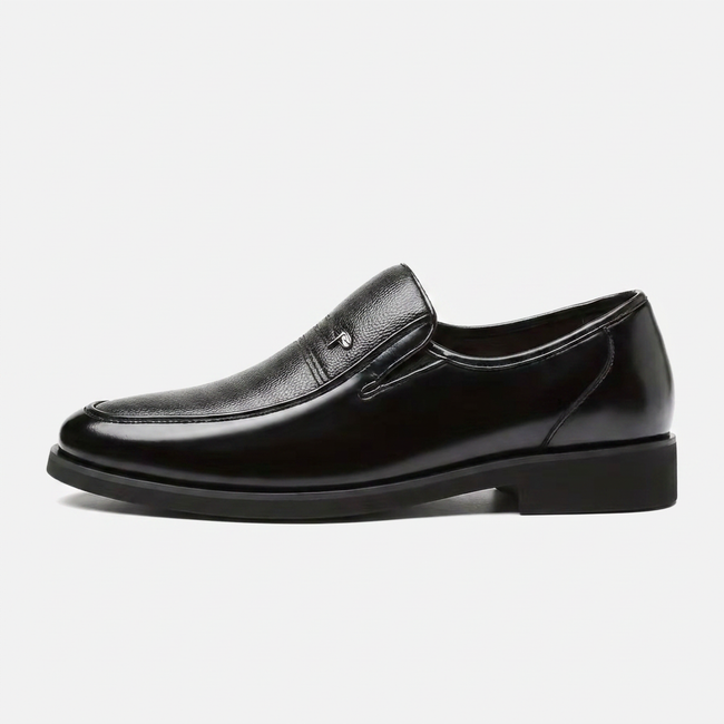 Side profile of men's leather slip-on business loafers by FJØRNA, showcasing sleek design and smooth leather finish.