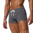 Men's striped swim shorts by FJØRNA with drawstring waist and quick-dry fabric, suitable for beach or poolside wear.