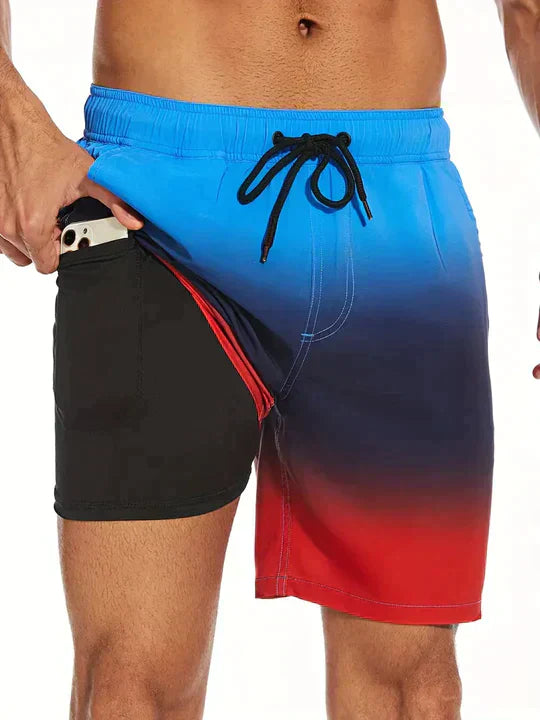 Men's FJØRNA swim shorts with vibrant multi-print design and built-in compression liner for comfortable swimming and water activities.