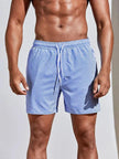 Men's FJØRNA pinstripe swim shorts with a drawstring waist, featuring a stylish striped pattern and comfortable fit.