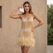 Model wearing FJØRNA's elegant mini dress with a V-neck and cami straps, showcasing a stylish women’s dress.