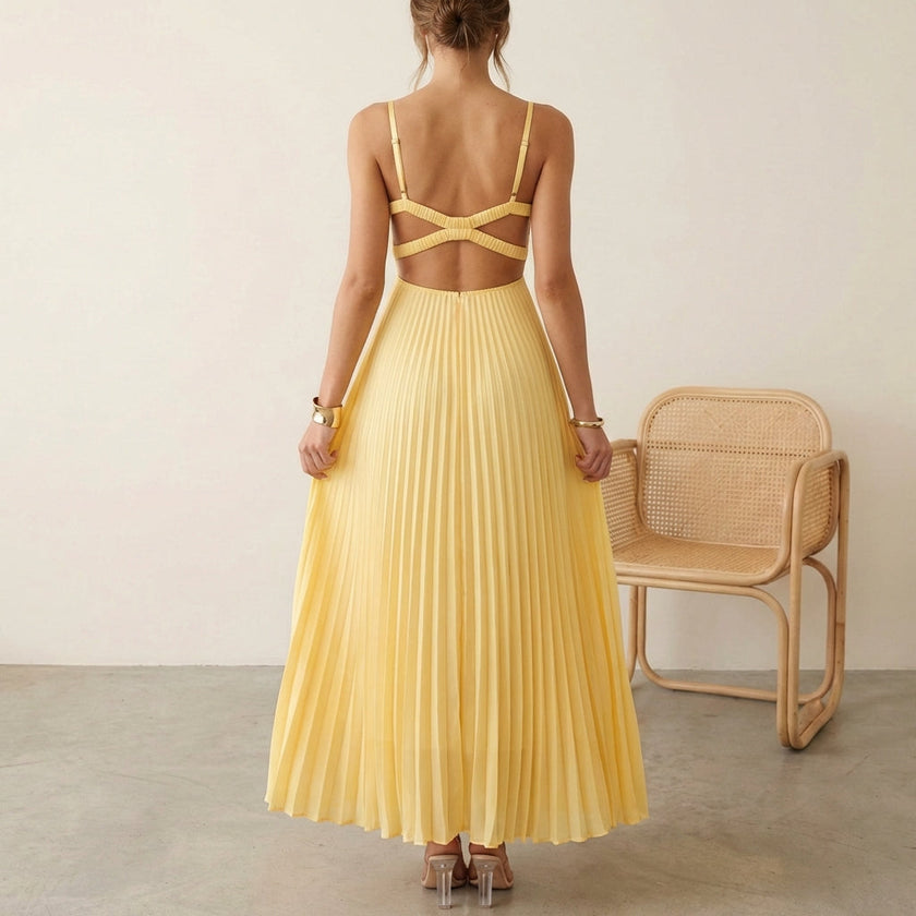 FJØRNA elegant sleeveless maxi dress with V-neck and pleated design worn by a model, perfect for stylish occasions.