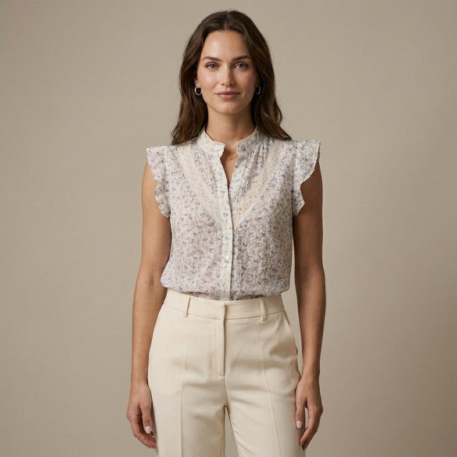FJØRNA women's floral sleeveless summer blouse worn by a model, light fabric, casual and stylish for warm weather.