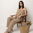FJØRNA women's summer two-piece set with wide-leg pants and matching lightweight top, modeled by a woman outdoors.