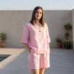 FJØRNA women's elegant two-piece co-ord set with V-neck top and matching lightweight pants, featuring pockets, on model.