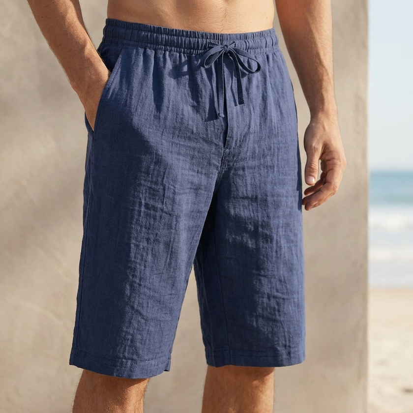 Navy blue men's linen chino shorts with drawstring waist and tailored fit, casual summer pants by FJØRNA.
