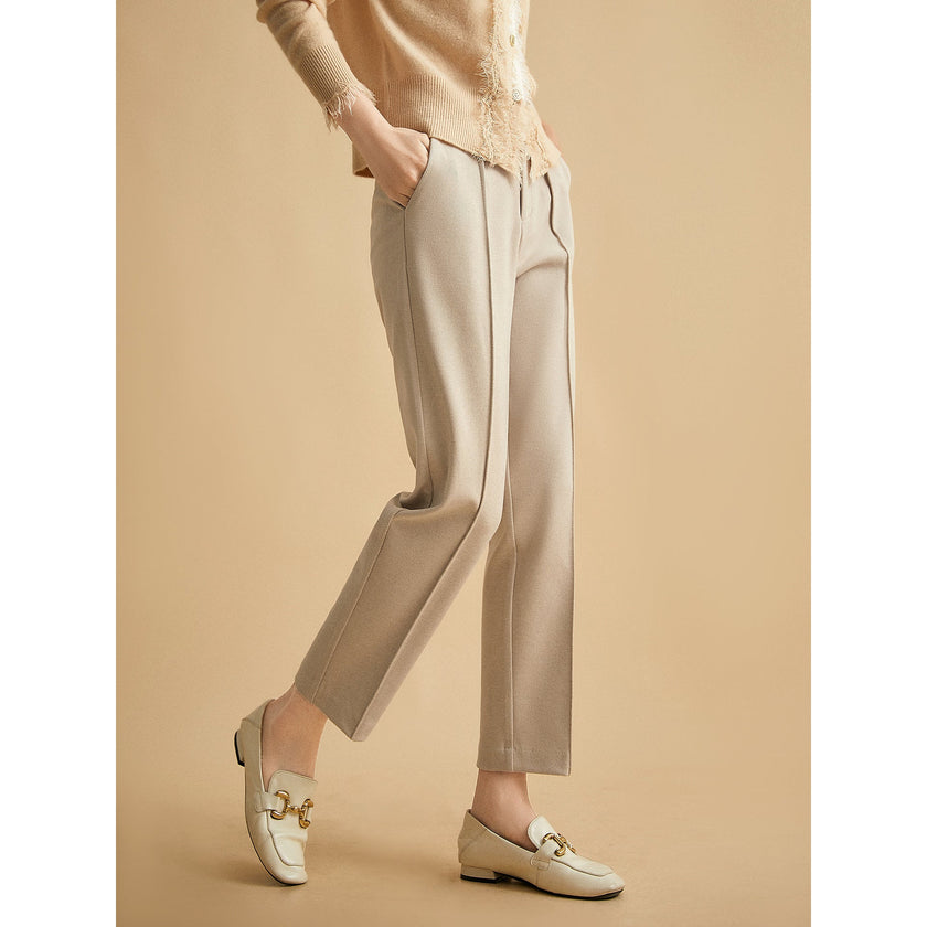 Women's wool tapered trousers by FJØRNA, made from soft merino wool, showcasing a stylish and comfortable fit.