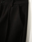 Women's Merino wool tapered trousers from FJØRNA, stylish and comfortable pants with a tailored fit, shown in a neutral fabric.