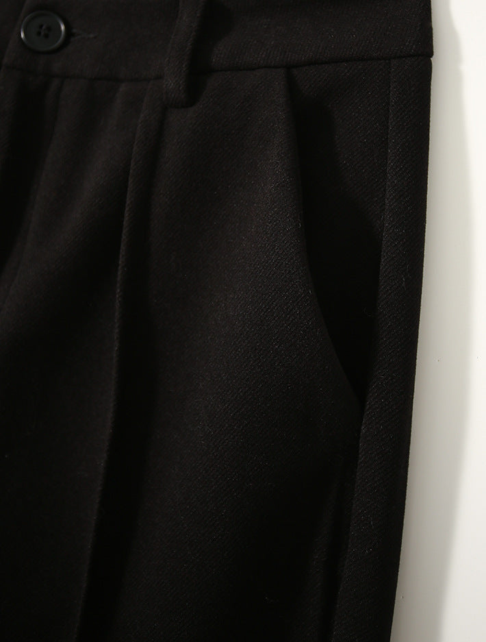 Women's Merino wool tapered trousers from FJØRNA, stylish and comfortable pants with a tailored fit, shown in a neutral fabric.