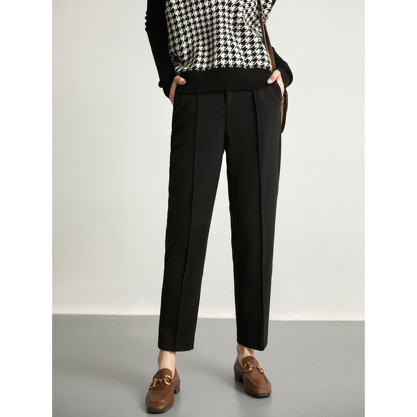 Women's wool tapered trousers by FJØRNA, classic merino wool pants with a tailored fit and smooth fabric detail.