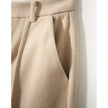 Women's wool tapered trousers by FJØRNA, featuring a comfortable fit and classic design, shown in a neutral color.