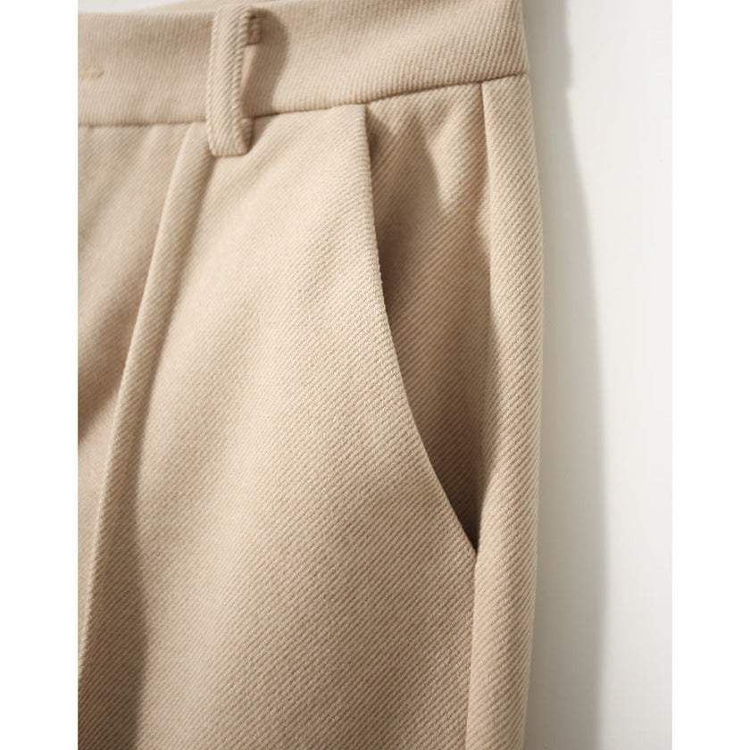 Women's wool tapered trousers by FJØRNA, featuring a comfortable fit and classic design, shown in a neutral color.