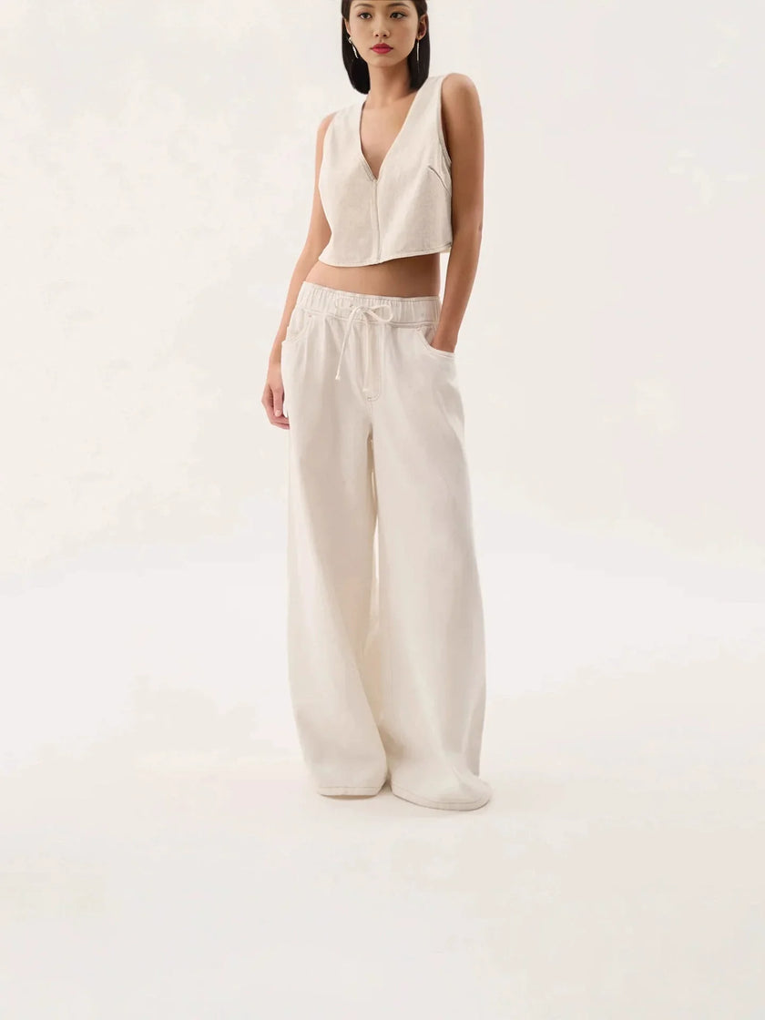 Blue denim wide-leg drawstring women's jeans from FJØRNA, featuring a relaxed fit and casual style.