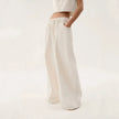 Blue denim wide-leg drawstring jeans for women by FJØRNA, relaxed fit pants with a casual style and comfortable waistband.