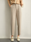 Women's wool tapered trousers by FJØRNA, merino wool pants for women, stylish tapered fit, visible fabric texture.