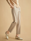 Women's wool tapered trousers by FJØRNA, stylish and cozy merino pants for women, shown in a natural fit and tapered design.
