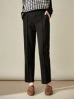 Women's wool tapered trousers by FJØRNA, cozy merino pants showcasing a fitted, tapered design and soft fabric.