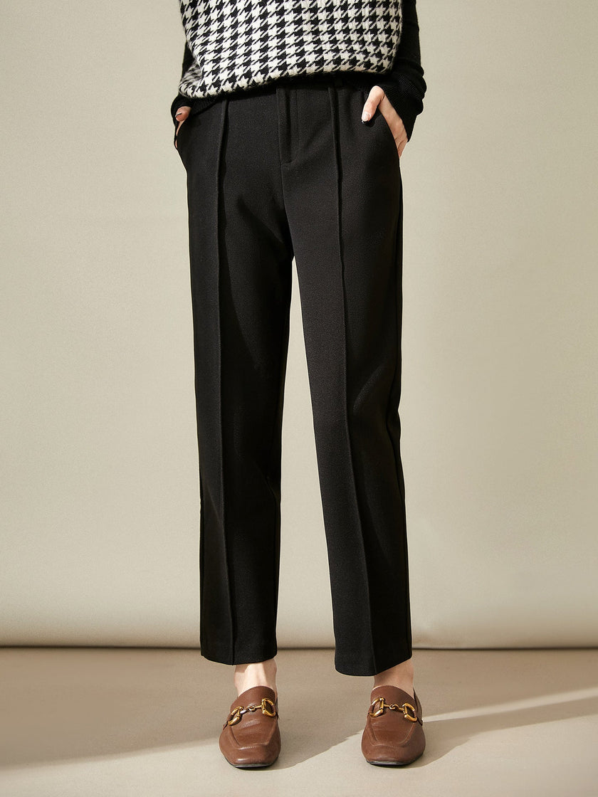 Women's wool tapered trousers by FJØRNA, cozy merino pants showcasing a fitted, tapered design and soft fabric.