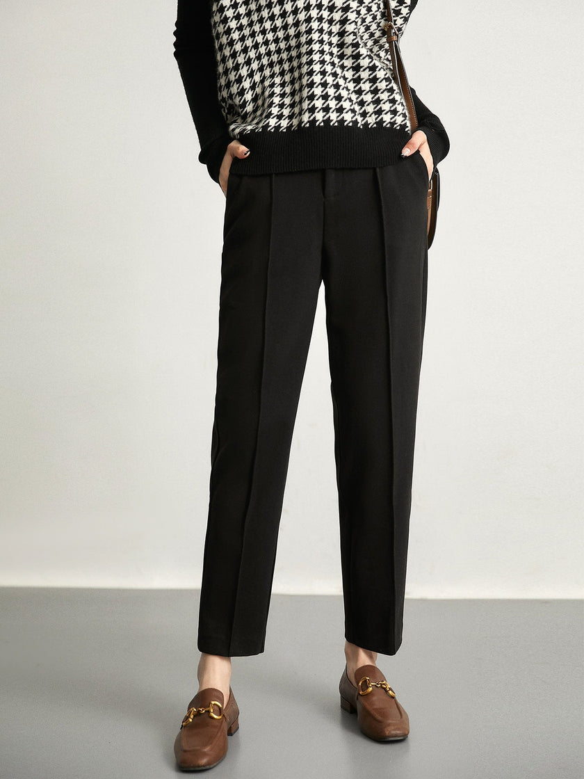 Women's wool tapered trousers by FJØRNA, Merino wool pants for women, showcasing a fitted, tapered leg design in neutral fabric.