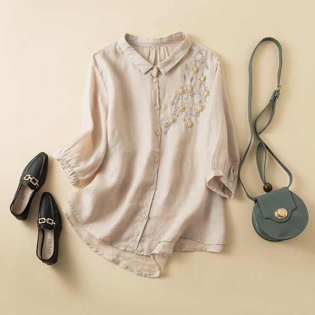 FJØRNA women's floral linen summer blouse with a relaxed fit, showcasing a vibrant floral print and lightweight fabric.