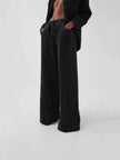 Blue denim wide-leg drawstring jeans for women by FJØRNA, relaxed fit with casual style, shown on a model.