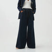 Blue denim wide-leg drawstring women's jeans by FJØRNA, relaxed fit pants with a casual style and adjustable waistband.
