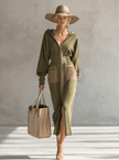 Green long sleeve maxi dress by FJØRNA, elegant evening dress with flowing fabric and fitted waist, shown on a model.