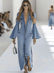 Light blue denim flared long sleeve jumpsuit for women by FJØRNA, featuring wide-leg pants and a fitted bodice.